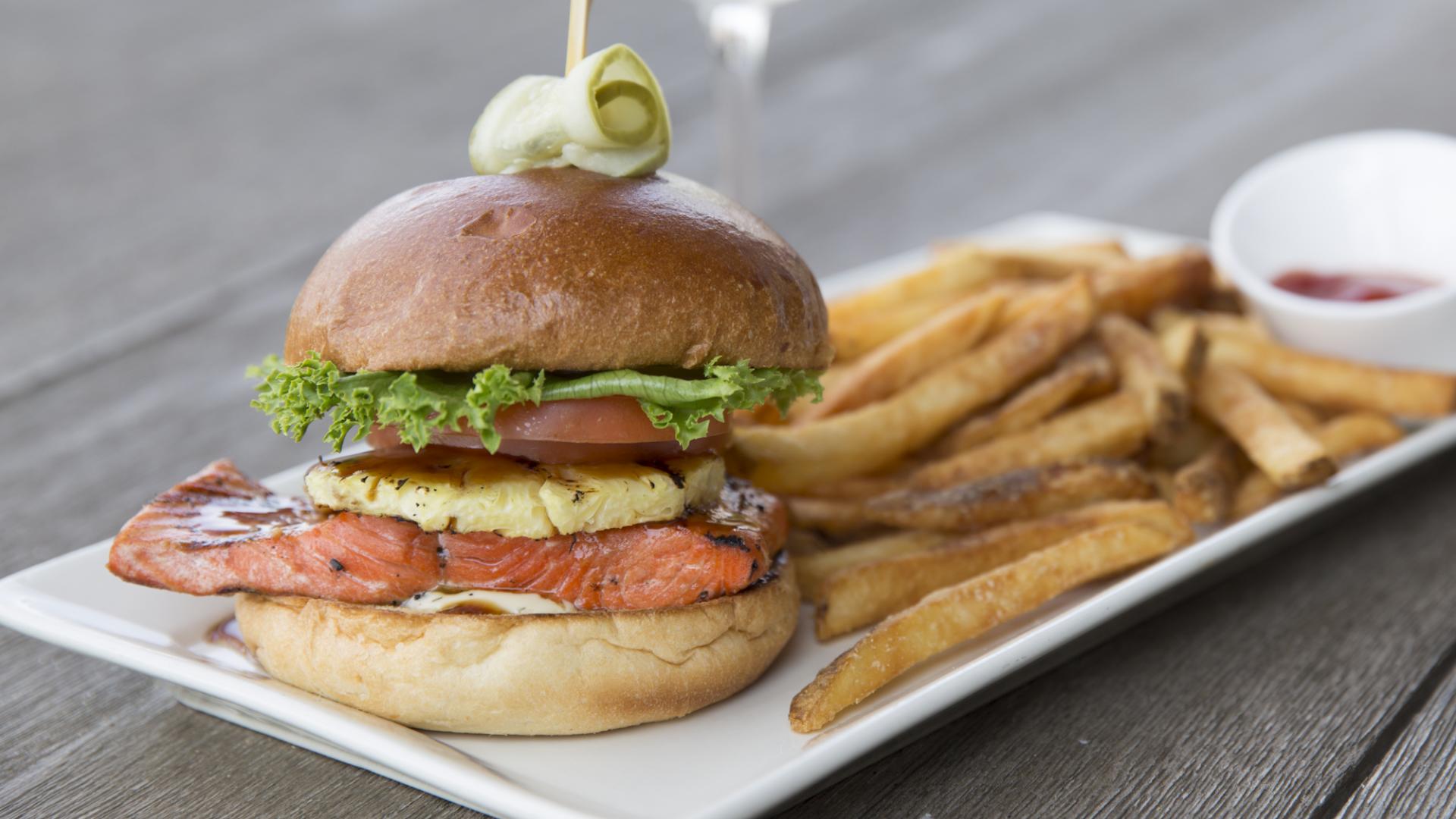 Grilled Salmon Burger - grilled pineapple, lettuce, tomato, teriyaki sauce and lemon aoli on a fresh brioche bun